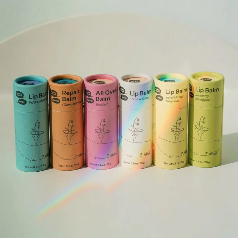 Six colorful tubes are lined up with a rainbow reflecting against them.