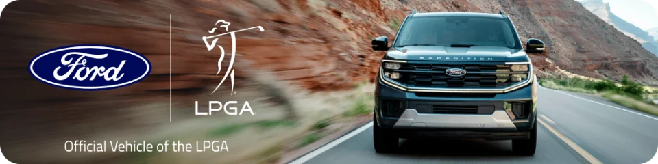 A front shot of an Expedition® SUV driving on a mountain road. To the left we see the Ford logo next to the LPGA logo with text below that reads "Official Vehicle of the LPGA".