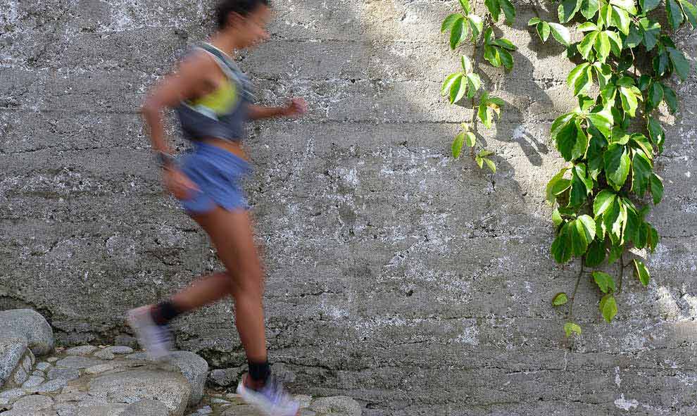 A person running down a stone staircase.