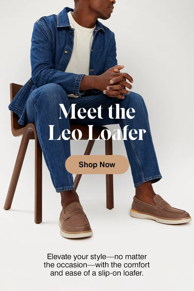 Man sitting in denim and brown nubuck leather Leo penny loafer. Shop men's shoes.