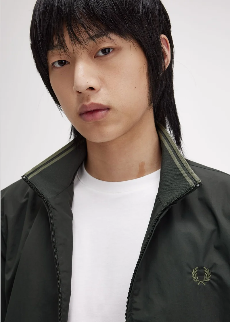 Male model wearing a lightweight Fred Perry Jacket