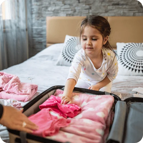 a mom and her daughter with an open suitcase in a hotel room a mom and her daughter with an open suitcase in a hotel room