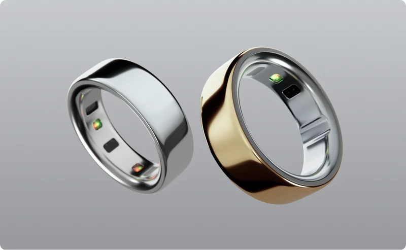 Silver and Gold Oura Ring on a gray background