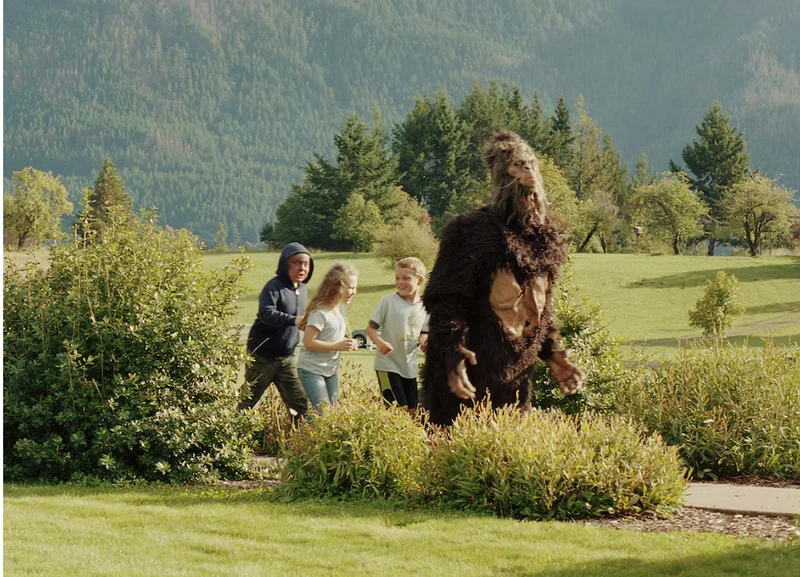 Children chase someone in a Bigfoot costume at the 2019 Bigfoot Bash in Home Valley, Washington.