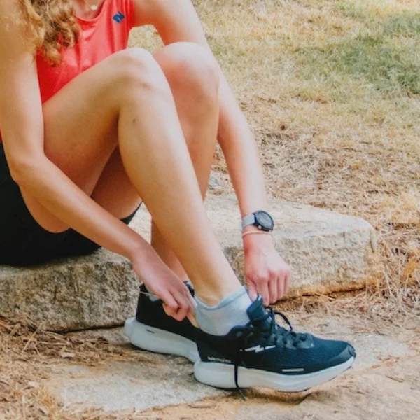 Woman putting on shoes