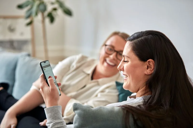 Two people looking at IKEA on their phone