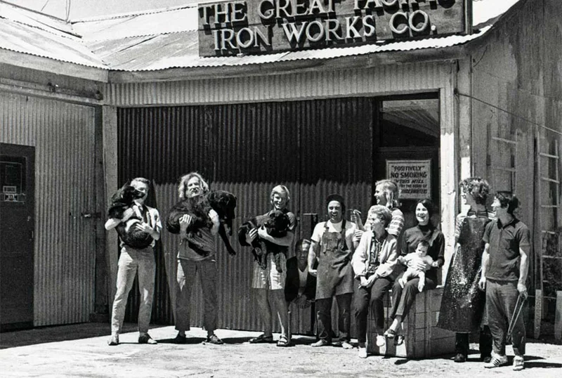 Employees with their dogs stand in front of the blacksmith shop at Patagonia headquarters in 1972.