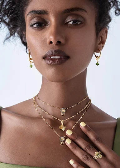 Model wearing Disney x Pandora jewelry inspired by Disney's Tiana