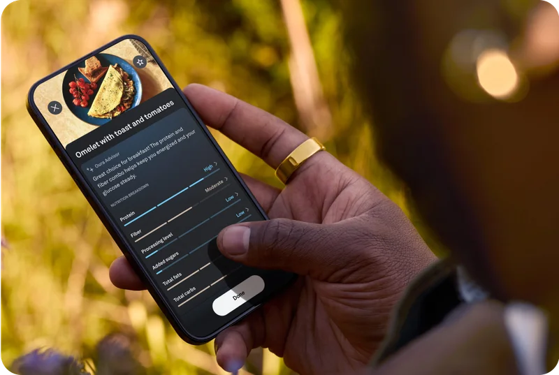 Person looking at Meals screen in Oura app wearing Oura Ring