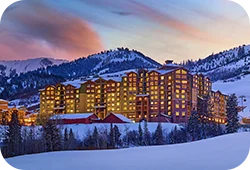 A
hotel in Park City, UT surrounded by snowy mountains.