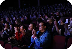 A group of Festival attendees cheering at a movie screening.