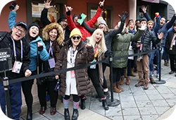 A group of Festival attendees waiting in line for a screening and cheering.