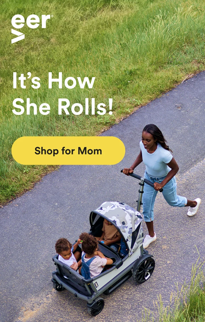 A mother pushing the Cruiser City XL on a paved path with her children