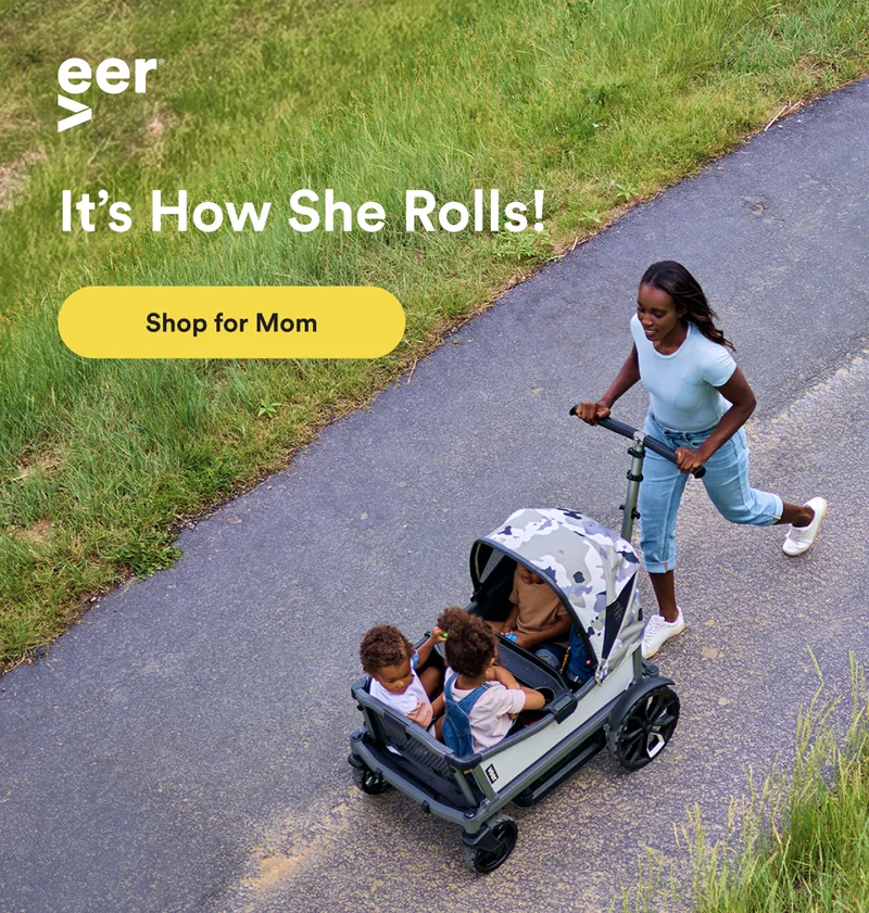 A mother pushing the Cruiser City XL on a paved path with her children