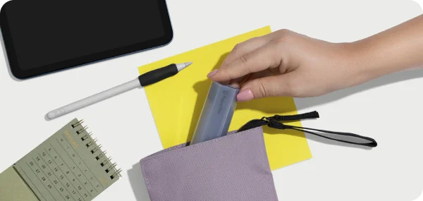The cleaning kit being put away in a pouch, surrounded by productivity tools.
