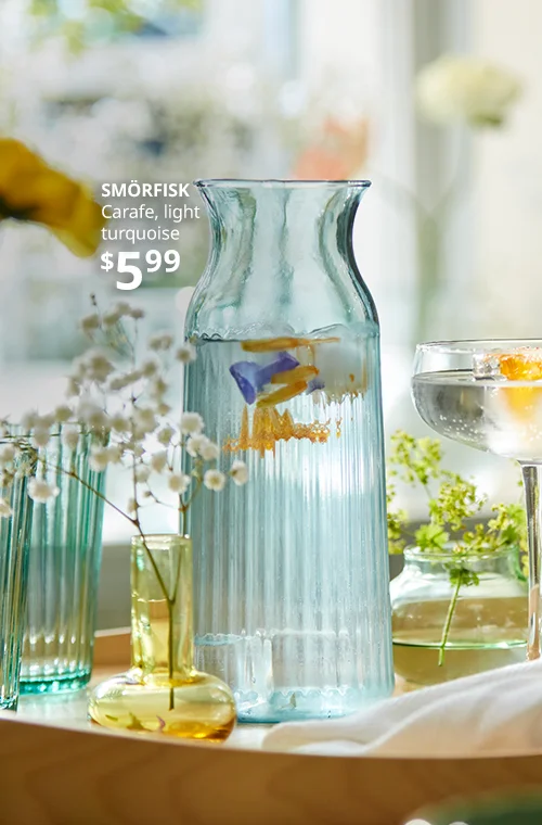 Teal carafe with flowers inside.