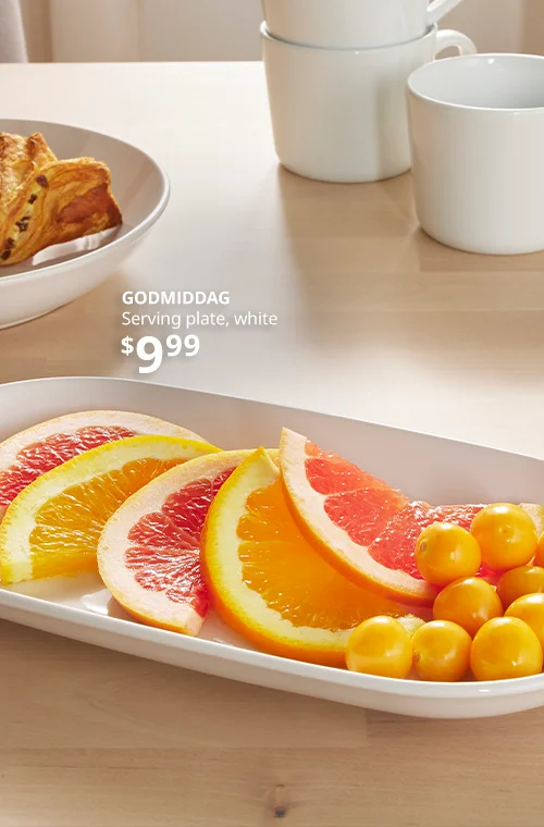 A white serving tray with slices of citrus fruits.