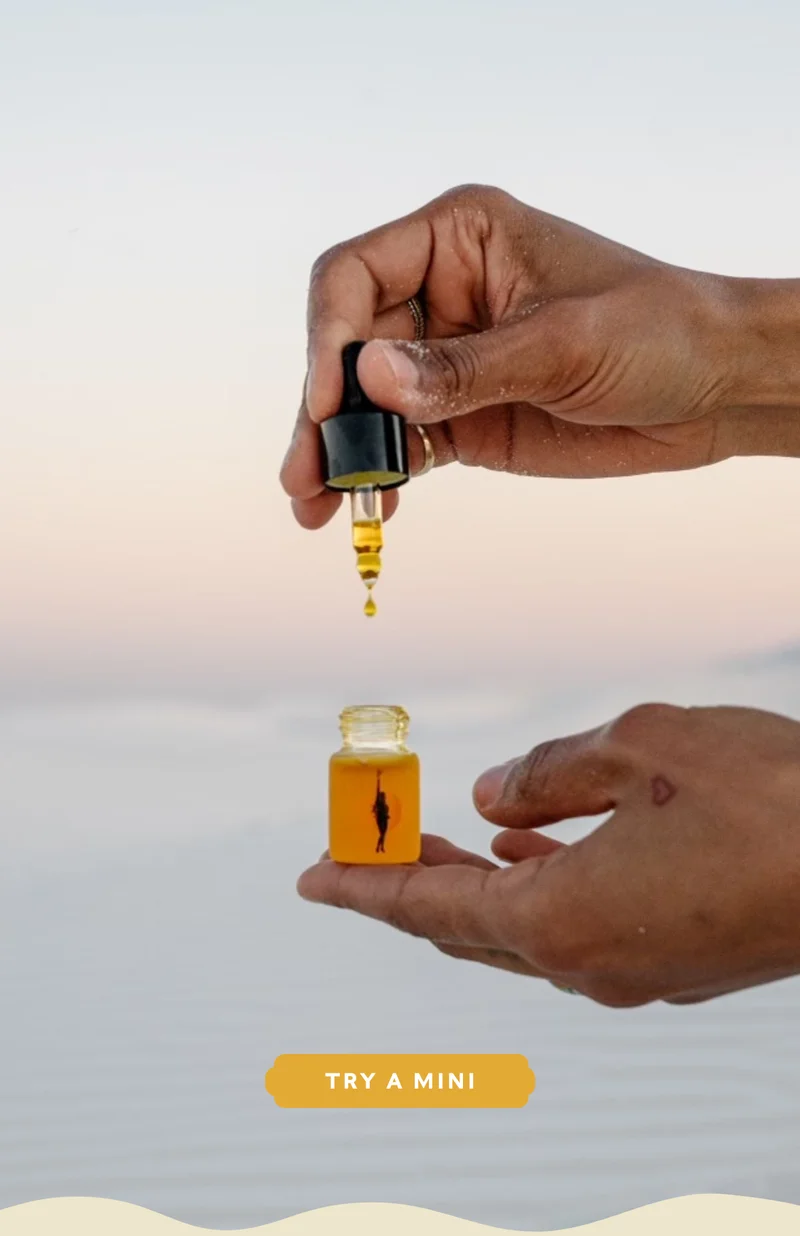 Hands holding a mini Face Oil