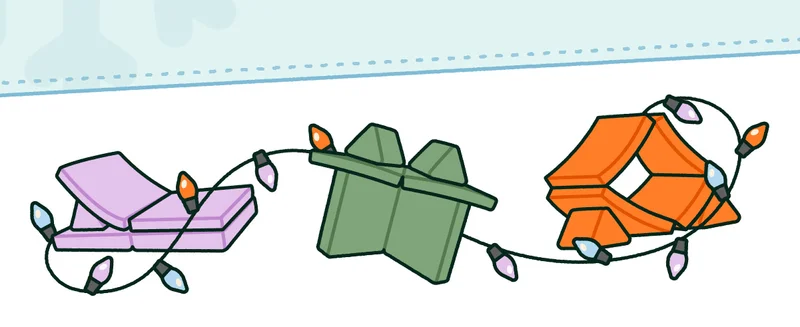 Three Nuggets in colors of Nuggeteer (now retired), Moonshot and Bamboo, covered in holiday lights.