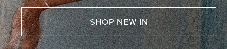 Text 'SHOP NEW IN' on a white banner over a sun-kissed arm against textured charcoal grey. Discover new collection fashion and latest products now.