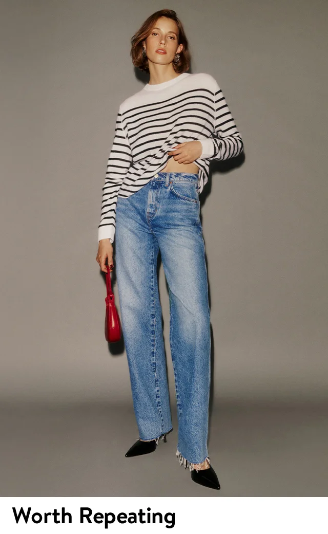 A woman wearing straight-leg jeans with a striped top.