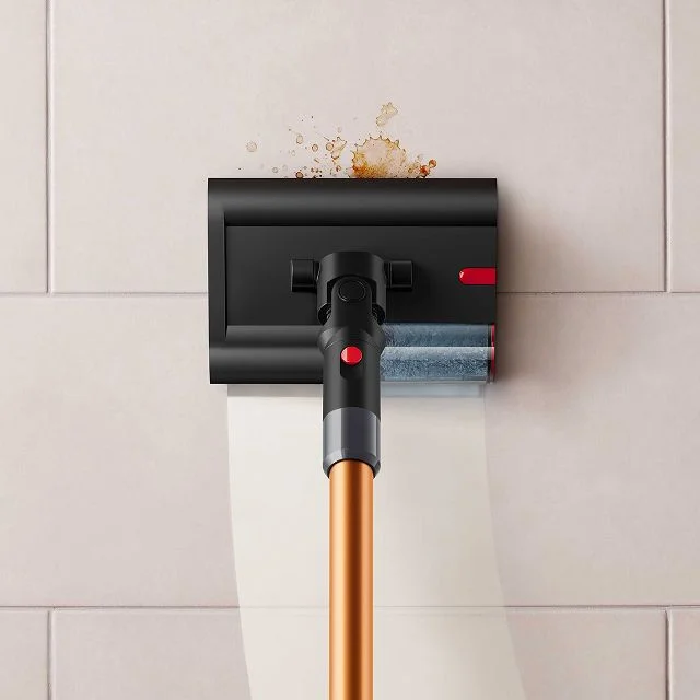 Close-up of the Dyson PencilWash cleaner head as it cleans a spill on a tiled floor