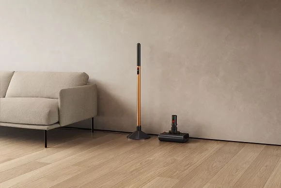 The Dyson PencilWash wand placed in its charging dock, and cleaner head in its drip tray