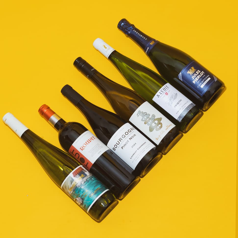 Six wines of the Tour de France lined up on a yellow background.
