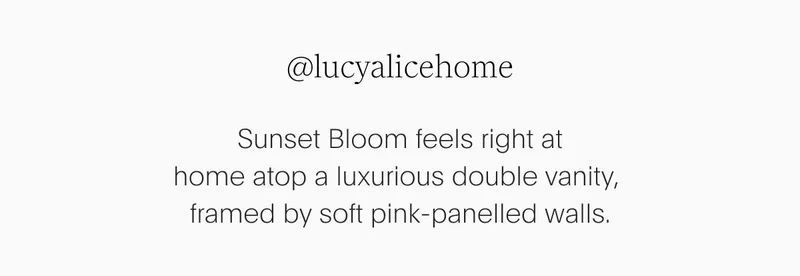 double vanity, framed by soft pink-panelled walls.