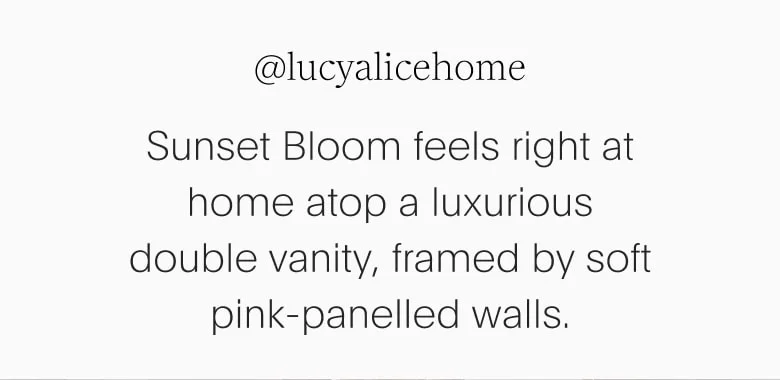 double vanity, framed by soft pink-panelled walls.