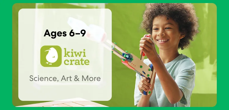 Young child smiling while working on a science experiment from KiwiCo Labs. Hands-on STEM learning for ages 6–9