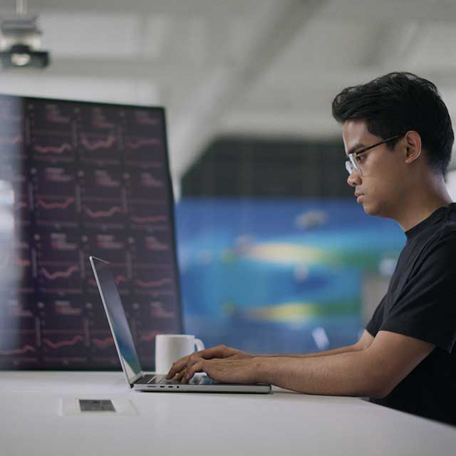 A Dyson air scientist examines air quality data on a computer screen.