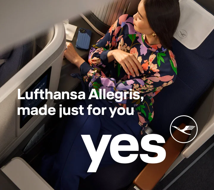 A woman enjoying the space and comfort of Business Class.