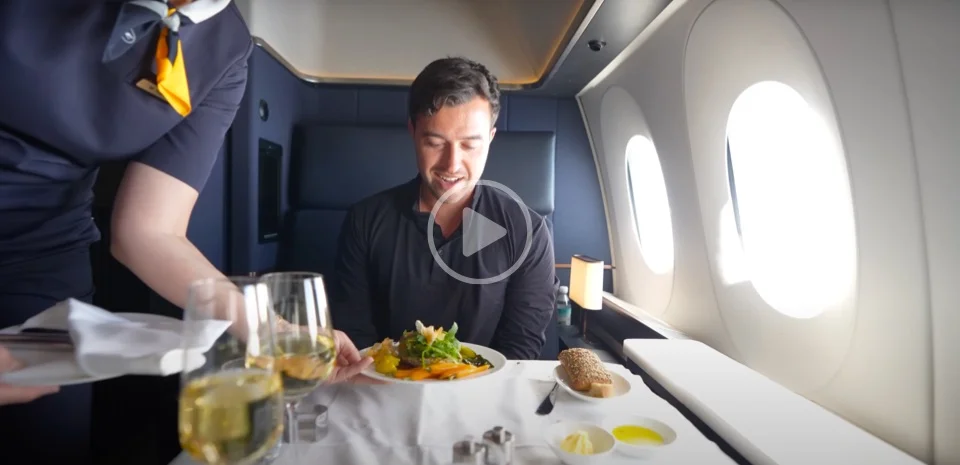 Travel content creator Brett Conti receives a snack mid-flight.
