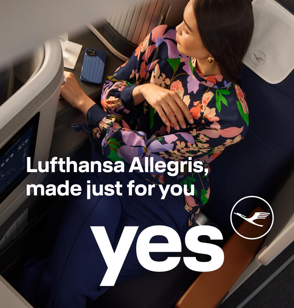 A woman enjoying the space and comfort of Business Class.