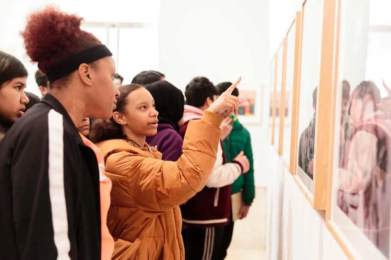 Visitors examining an artwork in the Brooklyn Museum galleries