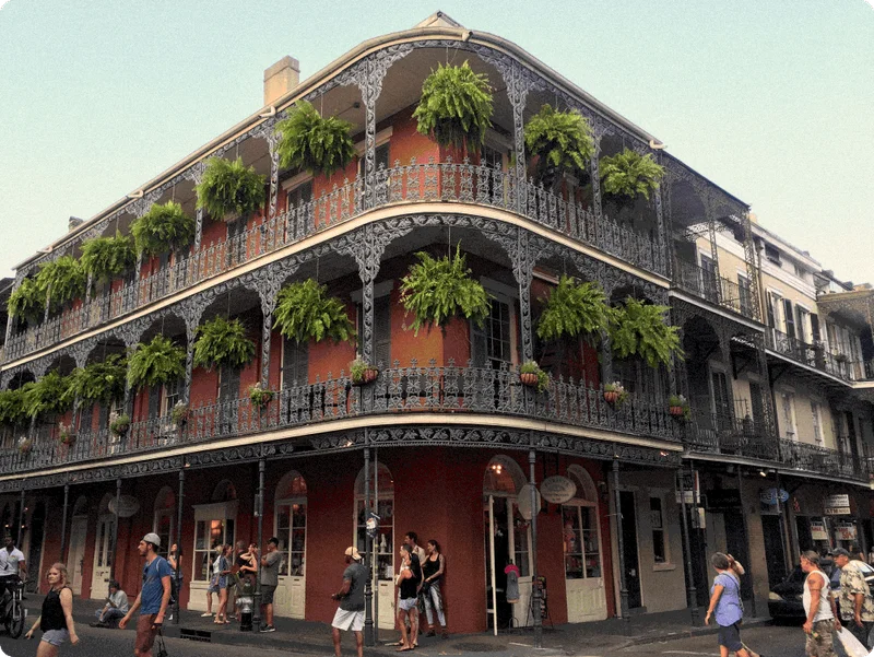Image Description: Travelers exploring the streets in front of the famous LaBranche House in New Orleans