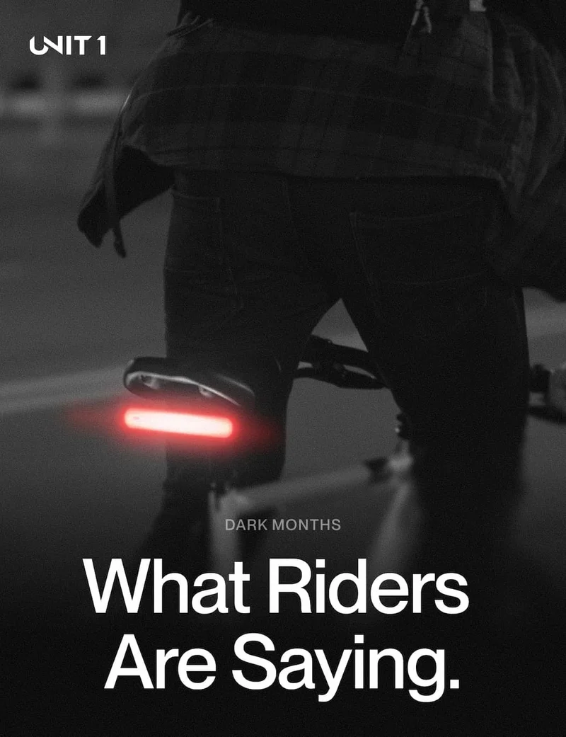 Cyclist riding at night with rear smart light glowing red. Headline: What Riders Are Saying.