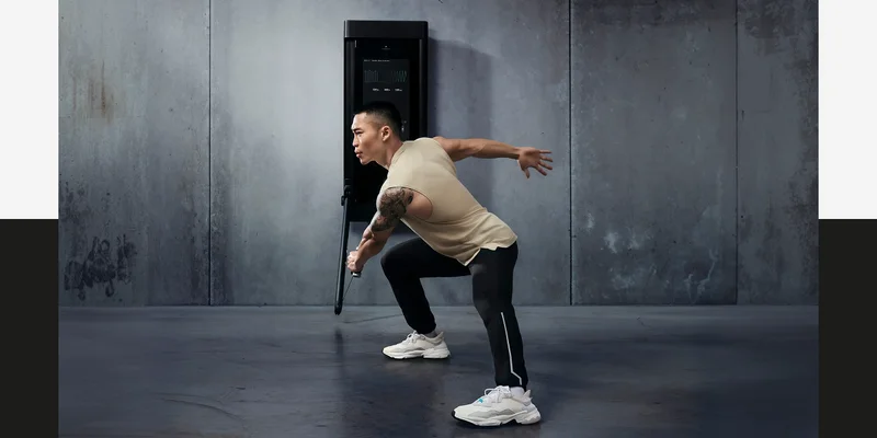 A man working out with Tonal 2