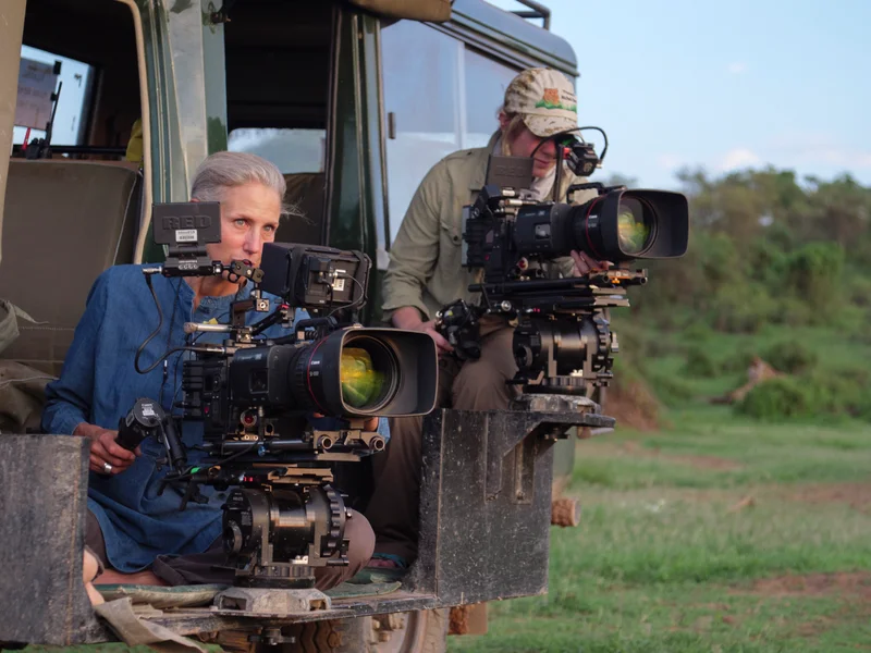 Queens' Director of Photography Sophie Darlington and Cinematographer and mentee
Erin Ranney film elephants from the vehicle. (National Geographic for Disney+/Faith
Musembi)