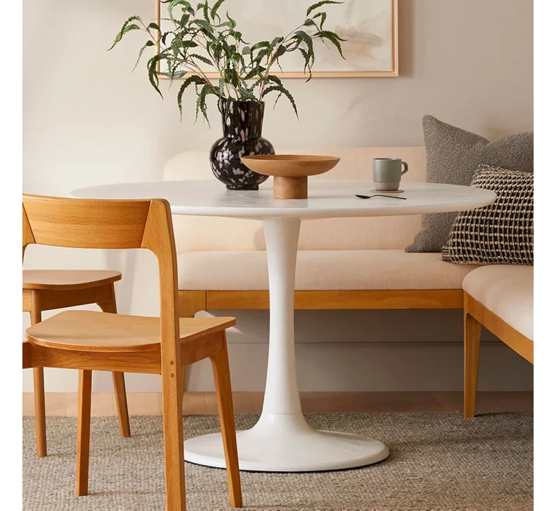 Our take on the classic tulip table is a small-space staple. Shop the Hendrick Dining Table.