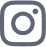 A close-up, flat-lay shot of the Instagram logo, a white camera icon with a rounded square outline in a muted blue-grey color.