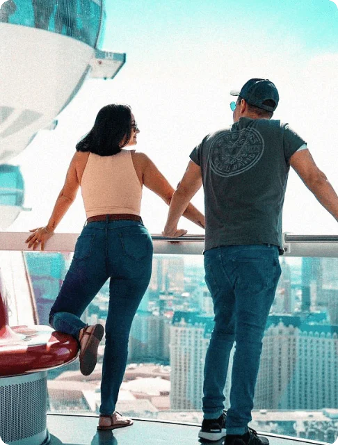 Image Description: A couple admiring the city skyline at the High Roller in Las Vegas