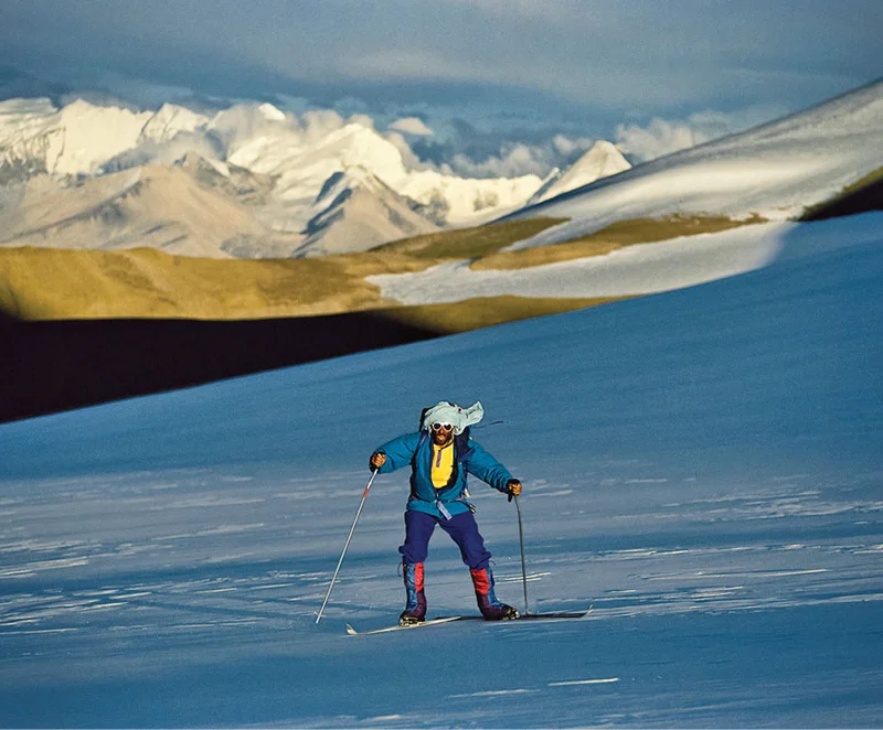 A person skiing in the mountains.