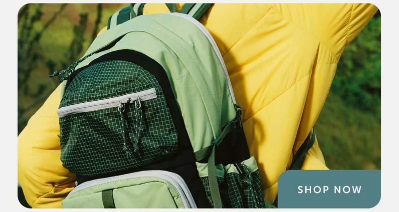 Image of a person wearing a green backpack - Shop Now