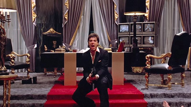 Image may contain: Al Pacino, Chair, Furniture, Clothing, Glove, Adult, Person, Cup, Throne, and Computer Hardware