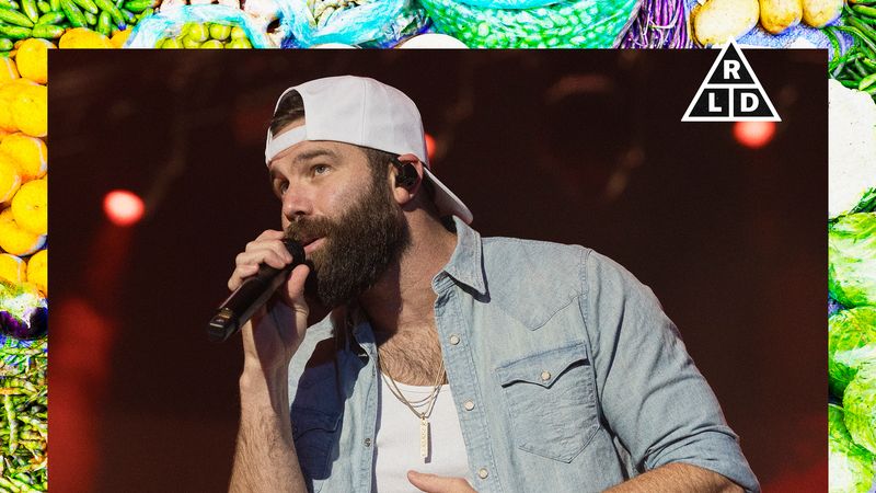 Image may contain: Dan Bilzerian, Baseball Cap, Cap, Clothing, Hat, Electrical Device, Microphone, Performer, and Person