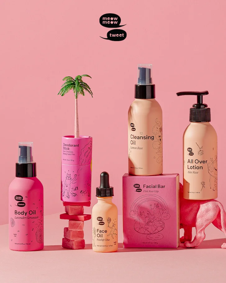 A grouping of skincare products all in pink packaging against a pink backdrop.