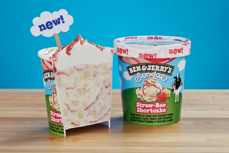 Pint of new Ben & Jerry's Straw-Bae Shortcake Sundae ice cream cut in half so you can see the whipped topping layer.