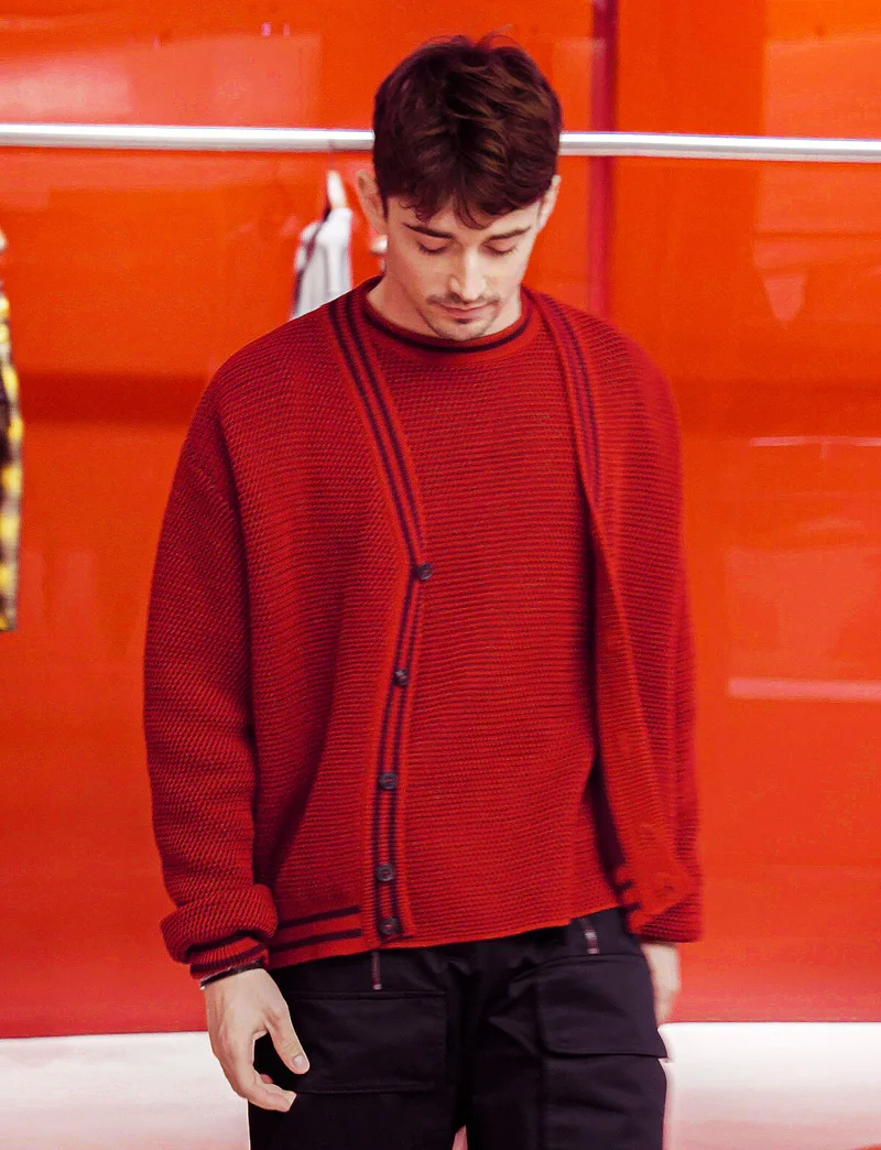 Charles Leclerc wears Ferrari knitwear in the Maranello boutique.